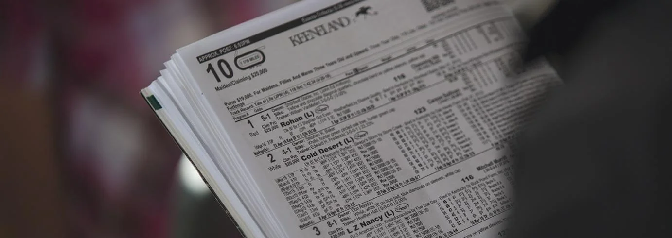 A printed Keeneland race programme showing past-performance information